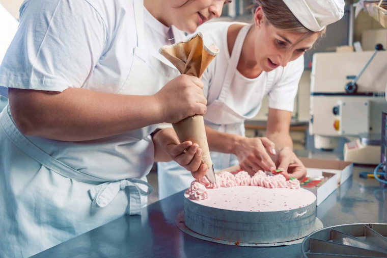 Lebensmittelhandwerk_Baeckerinnen bei der Arbeit an einer Torte